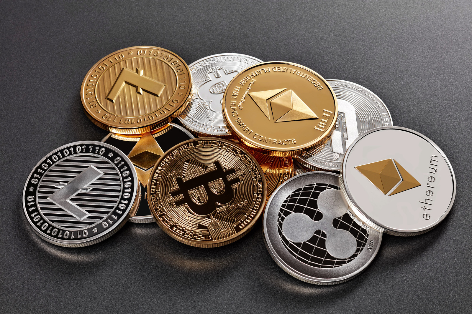 Different coins of crypto currency on a dark background