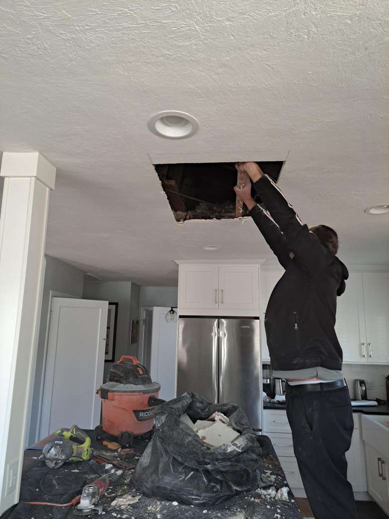 One our handyman's installing a top range hood in the kitchen